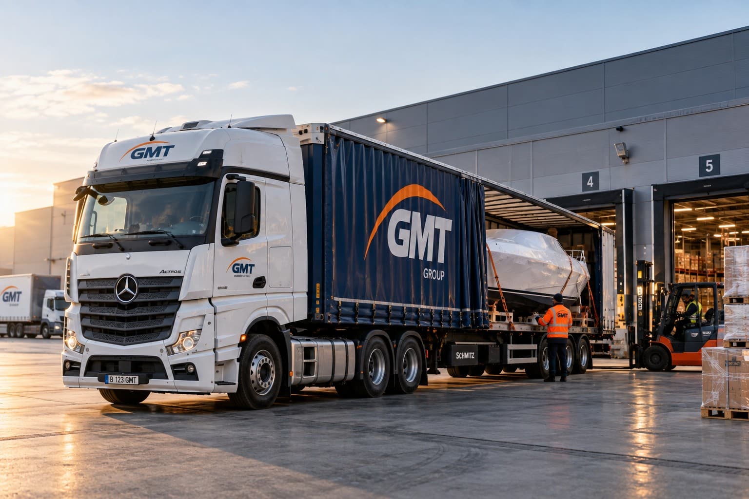 A boat secured on a GMT curtainsider trailer at a warehouse dock